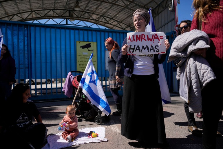 Israelis block the entrance to UNWRA, the main U.N. agency providing aid in the Gaza Strip, during a protest in Jerusalem, Wednesday, March 20, 2024. The UNRWA agency is reeling from allegations that 12 of its 13,000 Gaza staff members participated in the Oct. 7 Hamas attacks in southern Israel. (AP Photo/Ohad Zwigenberg)