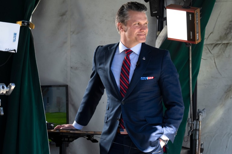 Pete Hegseth in front of lights for a camera shoot