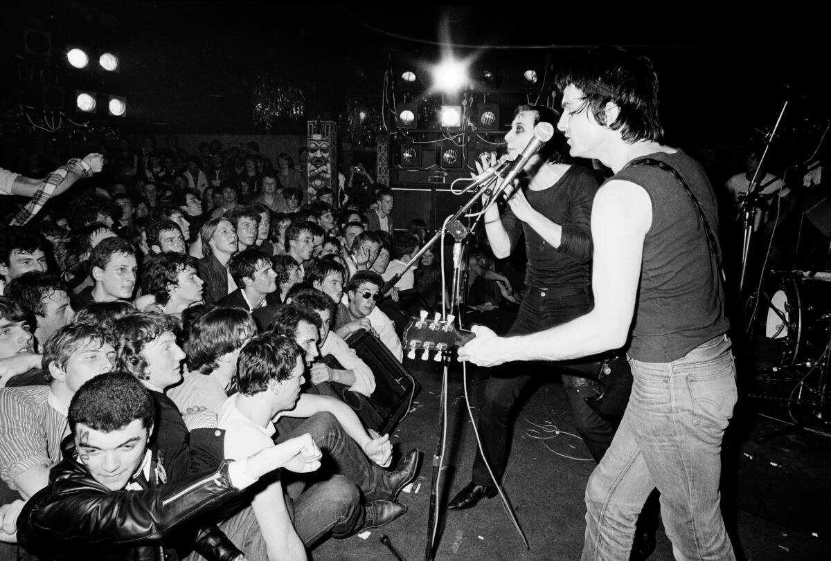 A punk audience crowds the front of the stage watching The Damned perform in London in 1978