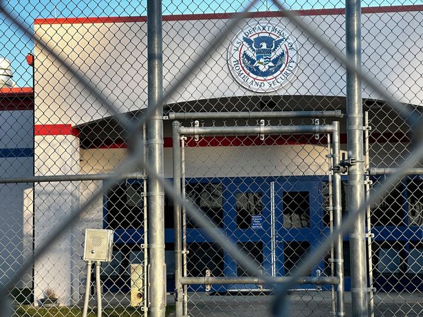 A photo of a US department building behind a fence