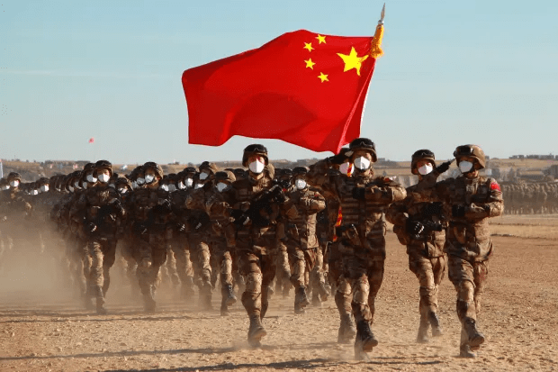 Chinese soldiers marching with their flag.