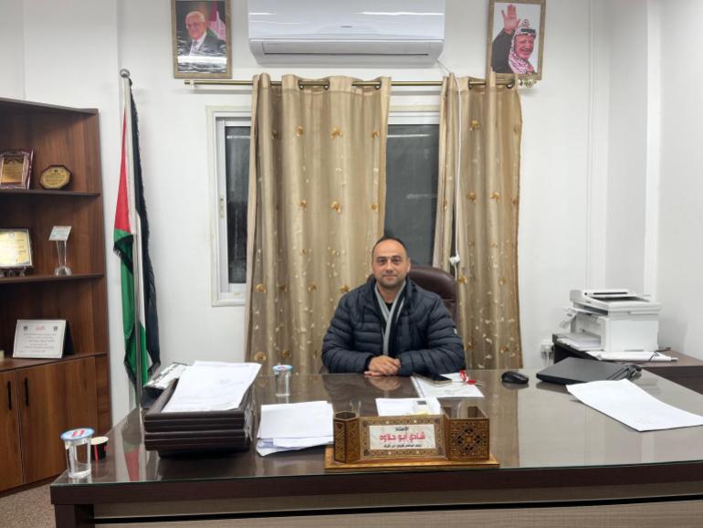 Deir Sharaf mayor behind a desk