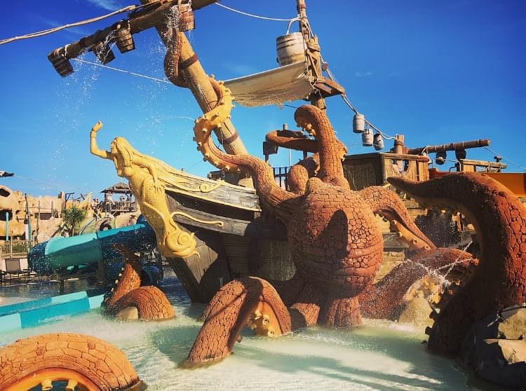 Water park structure of a ship and octopus with water features.