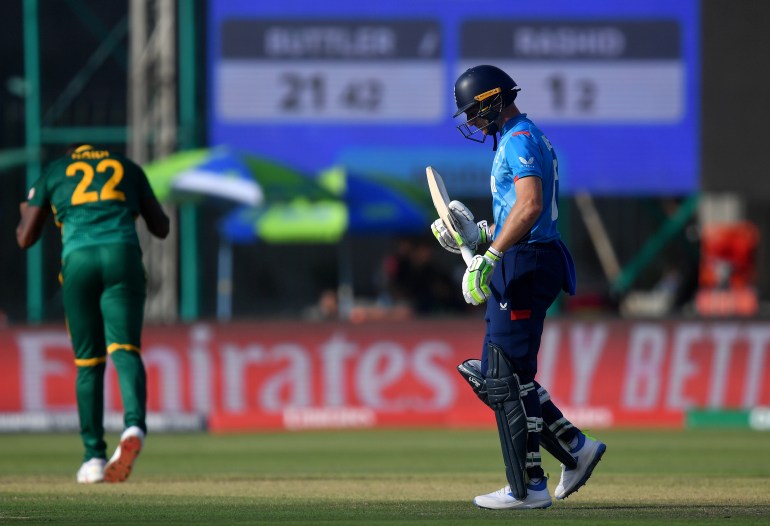 KARACHI, PAKISTAN - MARCH 01: Jos Buttler of England looks dejected as he leaves the field after caught out by Keshav Maharaj of South Africa (obscured) during the ICC Champions Trophy 2025 match between South Africa and England at National Stadium on March 01, 2025 in Karachi, Pakistan. (Photo by Sameer Ali/Getty Images)