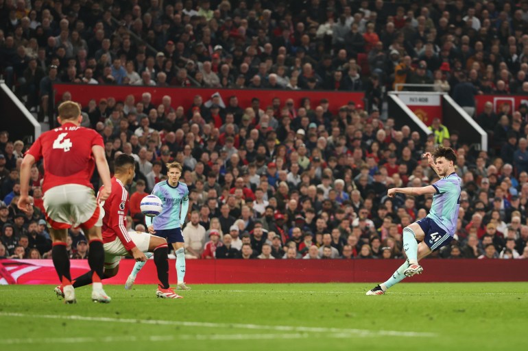 MANCHESTER, ENGLAND - MARCH 09: Declan Rice of Arsenal scores his team's first goal during the Premier League match between Manchester United FC and Arsenal FC at Old Trafford on March 09, 2025 in Manchester, England. (Photo by Carl Recine/Getty Images)