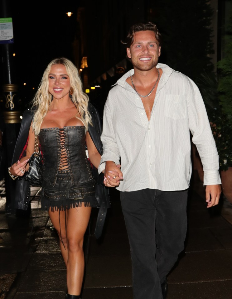 Gabby Allen and Casey O'Gorman holding hands at night.