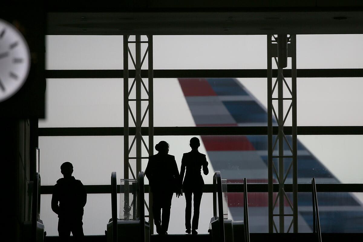 People are silhoutted against the windows at Tom Bradley International Terminal at LAX.