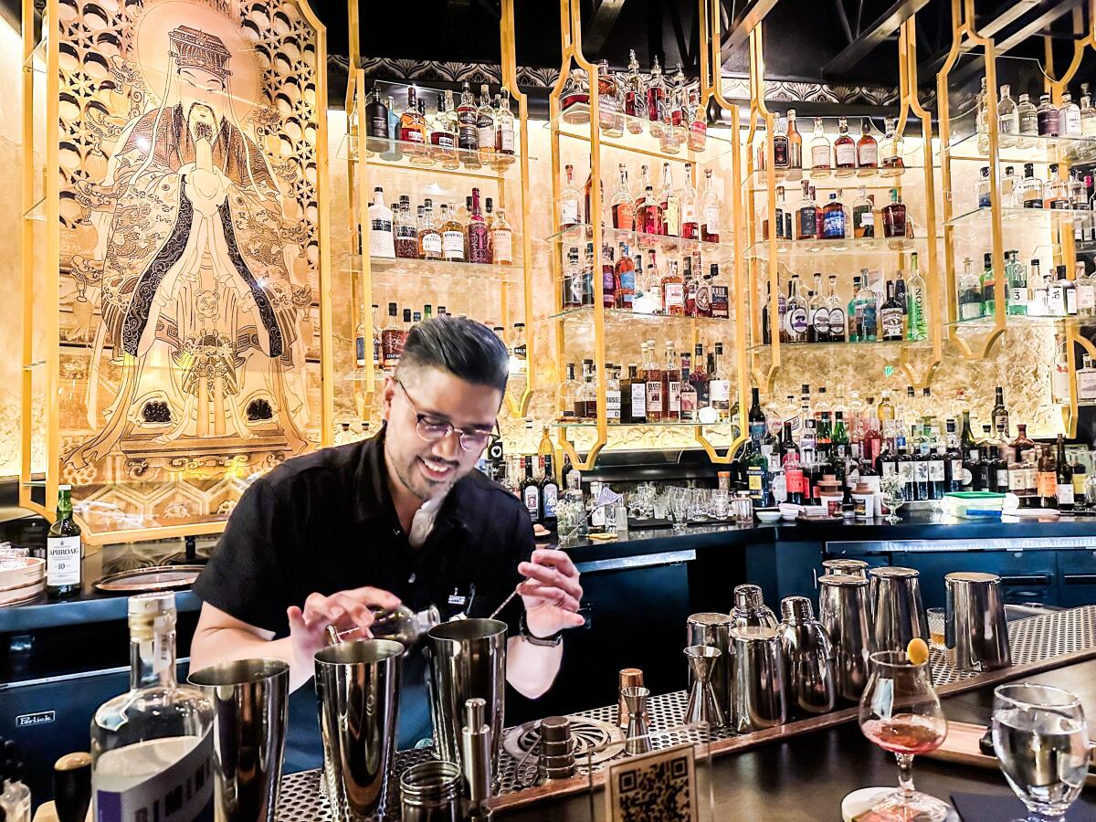 Bartender Brian Prugalidad mixes a cocktail at Realm of the 52 Remedies in San Diego.