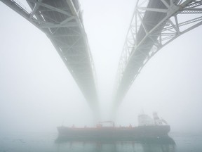 A ship makes its way down the St. Clair River under the Blue Water Bridge border crossing between Sarnia, Ontario and Port Huron, Michigan.