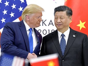 FILE - President Donald Trump, left, shakes hands with China's President Xi Jinping during a meeting on the sidelines of the G-20 summit in Osaka, Japan, June 29, 2019.