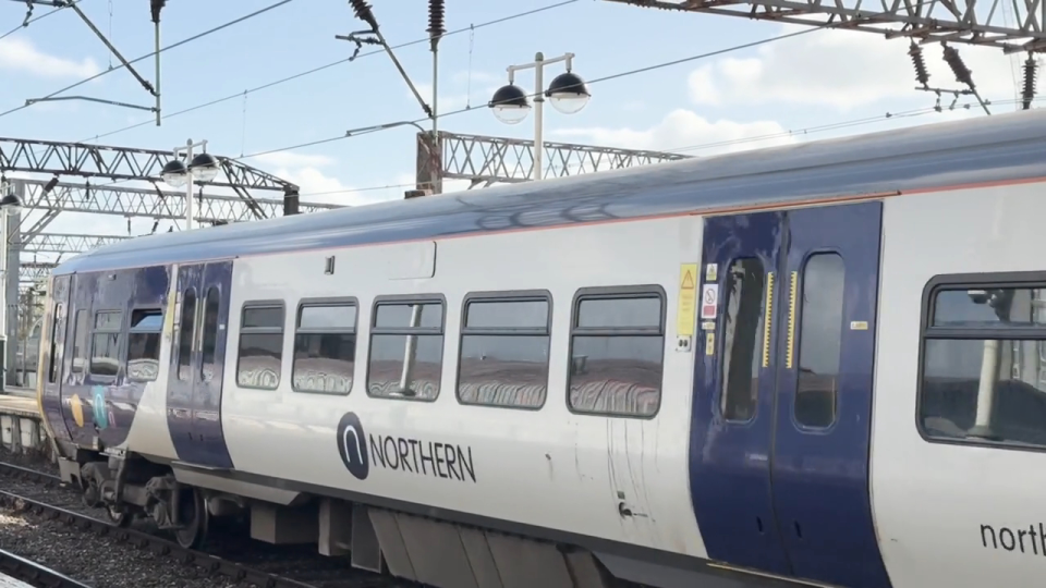 A white and purple Northern train at Manchester Piccadilly station.