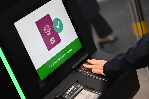 A person as their passport scanned whilst using an Automated European Union Entry/Exit System (EES) kiosk during a press preview on the rollout of the EU's new Entry-Exit System (EES) at Eurotunnel, south east England on September 23, 2025. The European Union's new border-check system for non-EU nationals, the so-called Entry/Exit System (EES), which will do away with passport stamps, is set to finally launch October 12. (Photo by Justin TALLIS / AFP) (Photo by JUSTIN TALLIS/AFP via Getty Images)