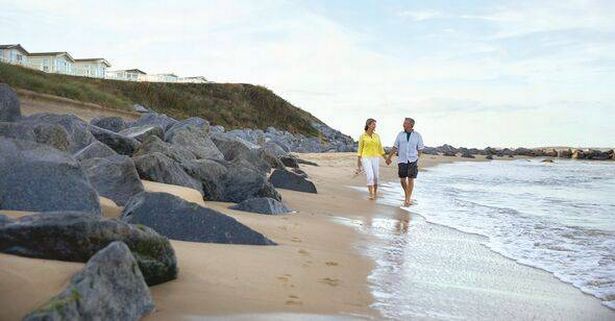 Couple walking on Hopton Beach