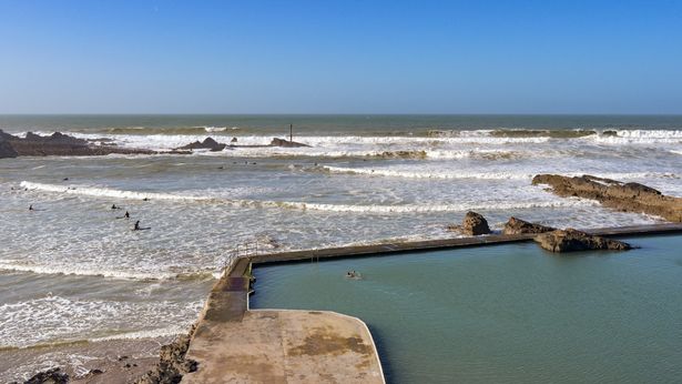 Aerial view of the Bude Sea Swimming Pool set in rocks above the beach.