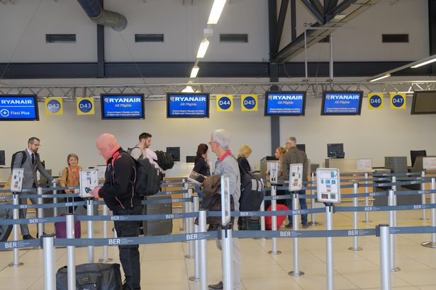 Check in at airport. People in a row to boarding on a Ryanair flight