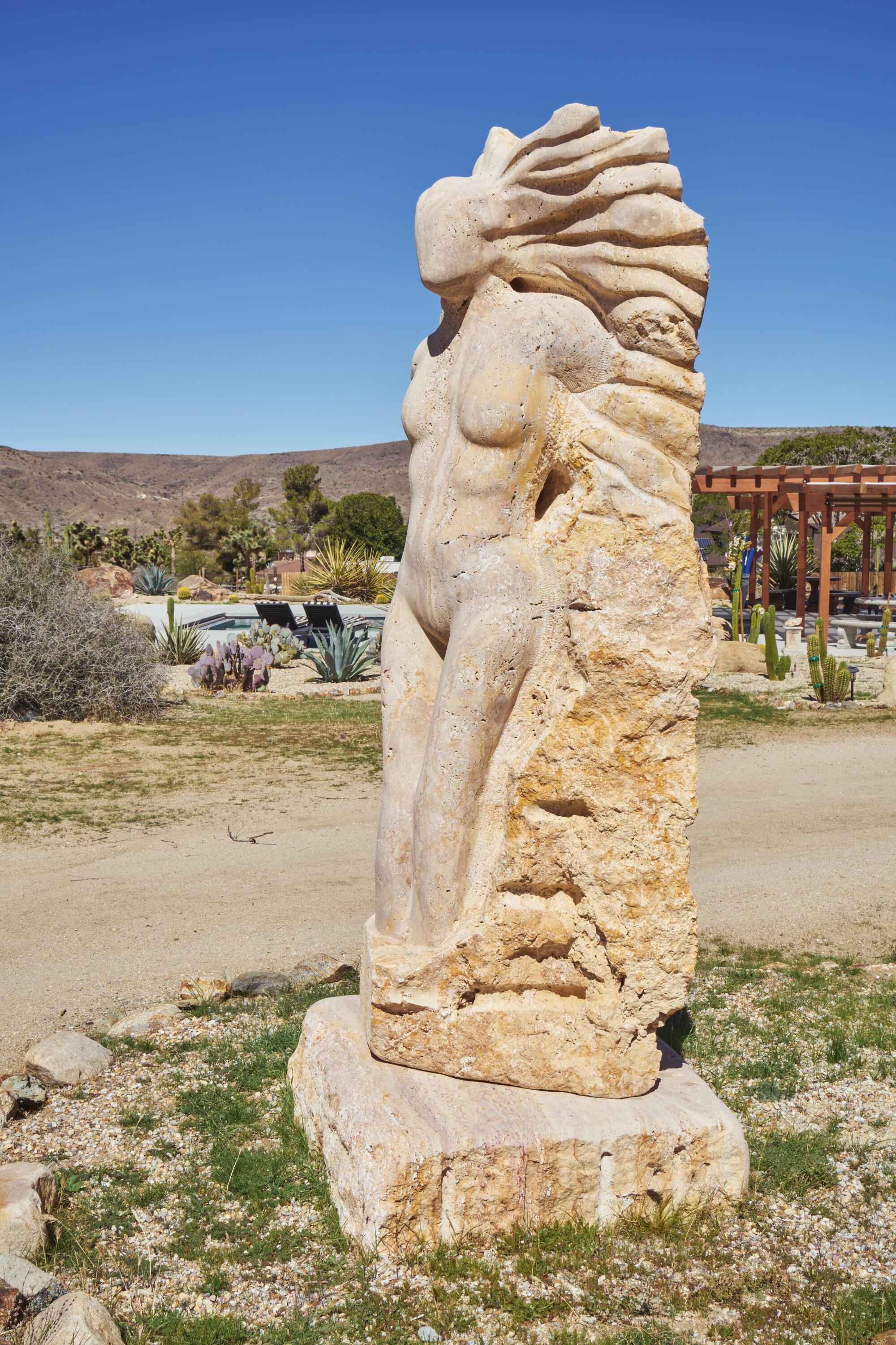 A statue of a woman bracing against the wind.