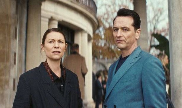 A woman and a man stand outside