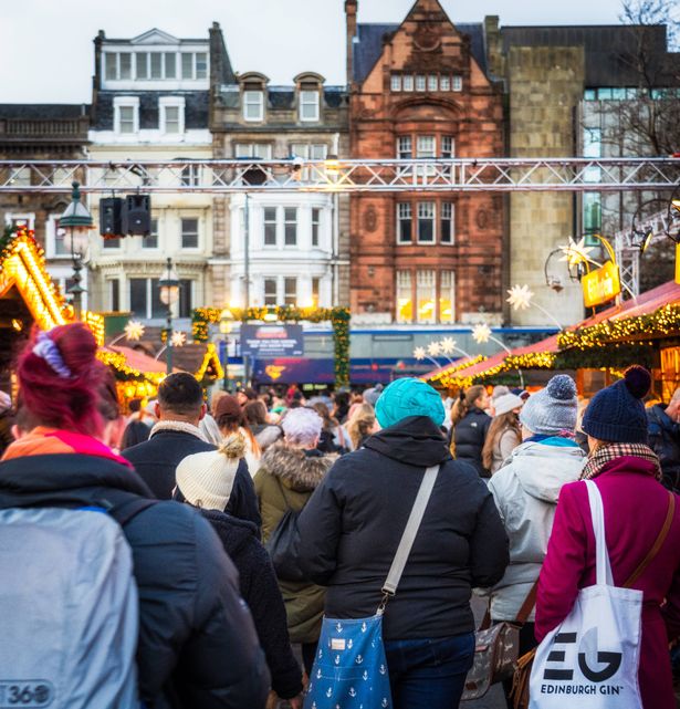 Edinburgh, Scotland - People passing decorated stalls at Christmas Markets off Princes Street in central Edinburgh during December.