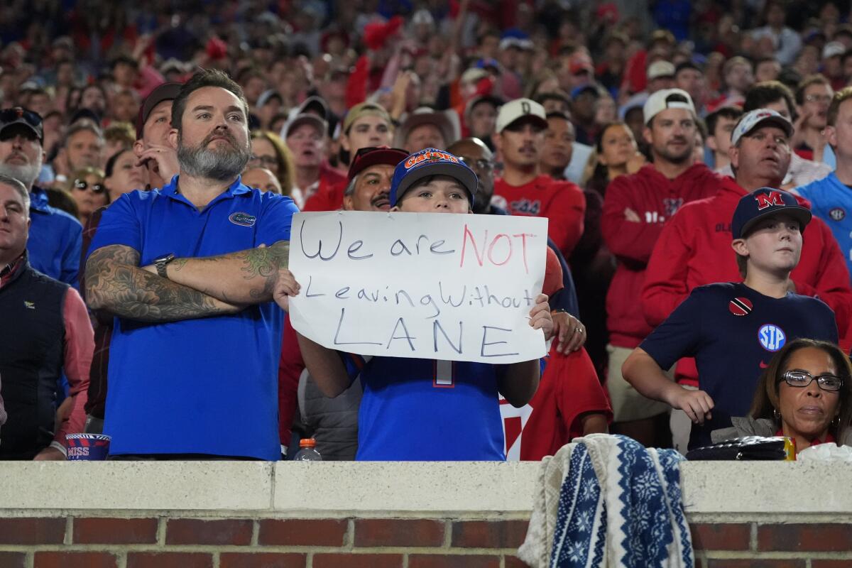 A young fan shows his support for Mississippi coach Lane Kiffin.