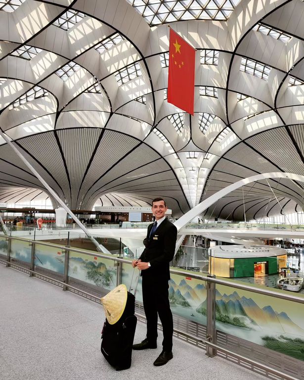 Mateusz with his suitcase in an airport