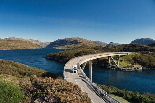 Camper van on holiday, driving the North Coast 500, crossing the Kylesku Bridge, Kylesku, Scotland