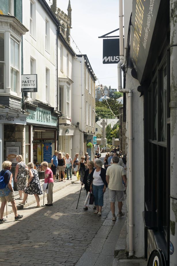 St.Ives, UK - June 16, 2015: Various people walking, shopping etc on the cobbled streets of St. Ives, Cornwall on a bright June day.