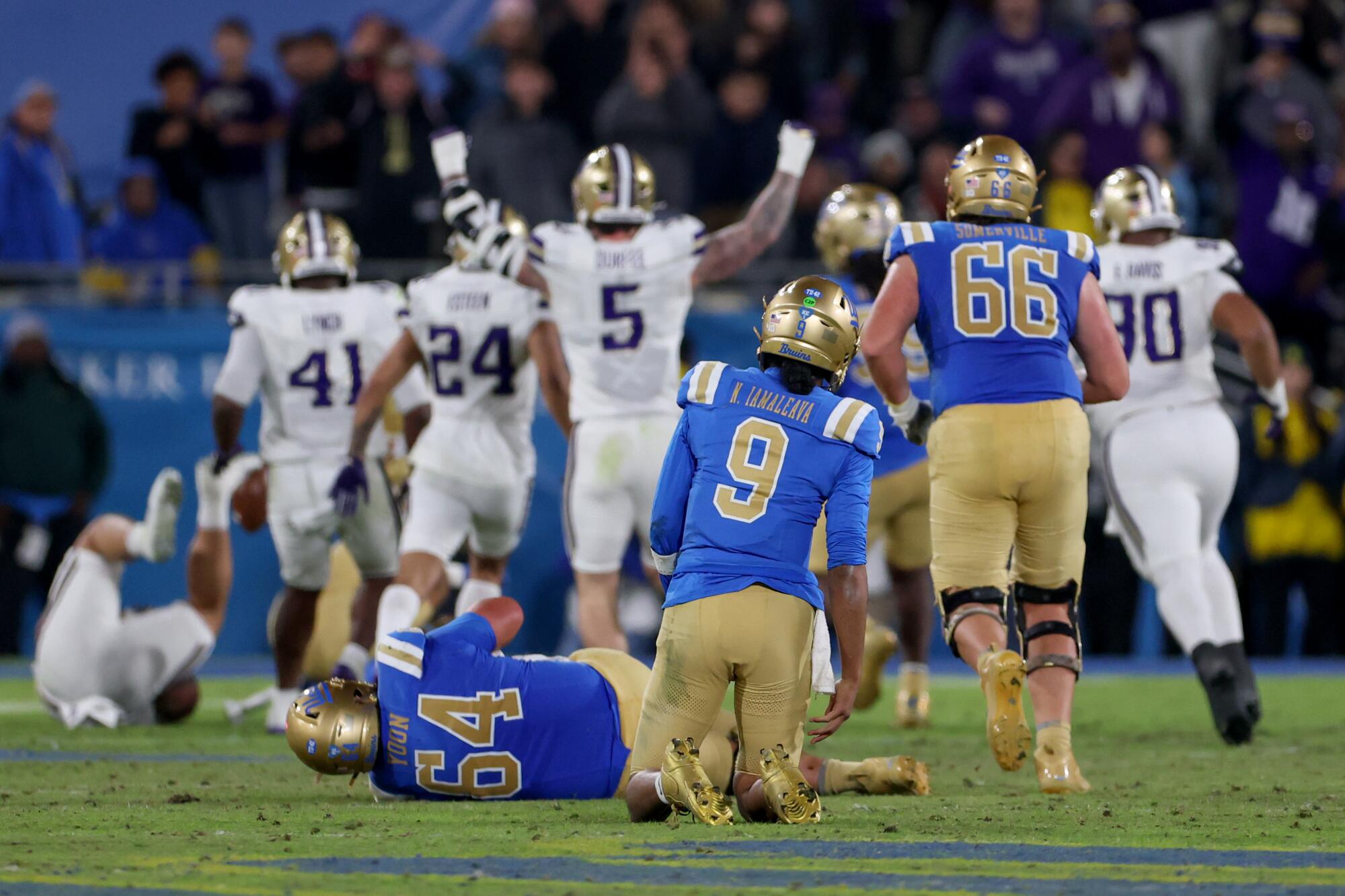 UCLA quarterback Nico Iamaleava watches as Washington players celebrate a defensive touchdown in the first half Saturday.