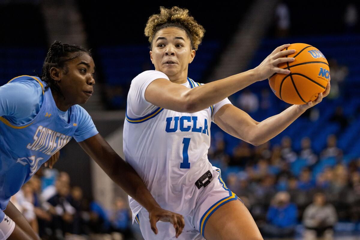 UCLA guard Kiki Rice (1) looks to pass the ball against Southern forward DeMya Porter.