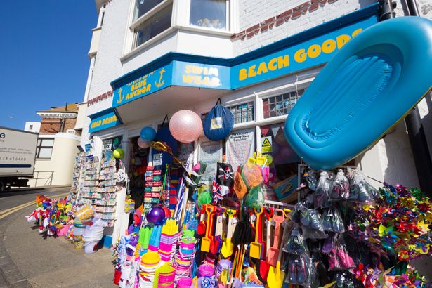  variety of colourful seafront paraphernalia on sale for beachgoers in the Blue Anchor in Broadstairs. These include flags and paper windmills. 