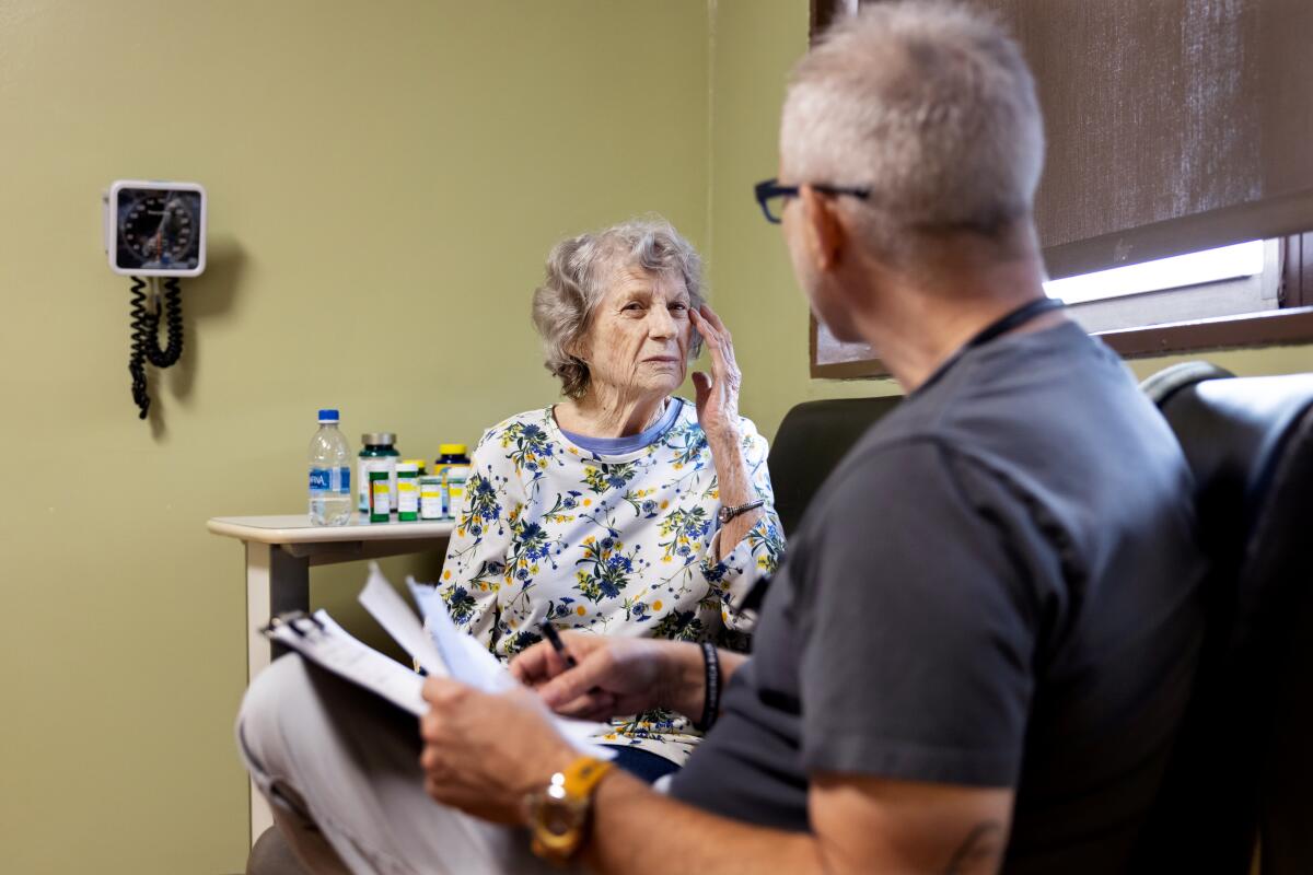Rose Mary Wampler, 88, sees physician assistant Chris Pilaczynski at the clinic