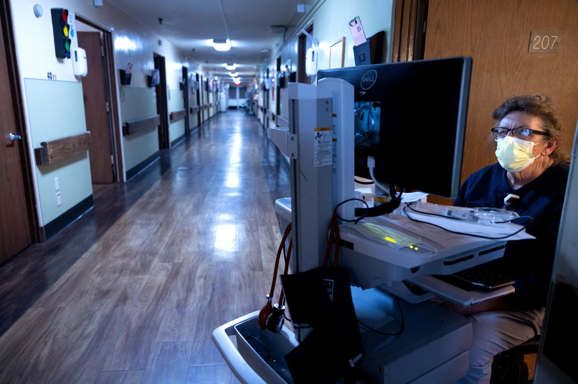 T-Ann Pearce  sits in the medical surgical unit during her shift
