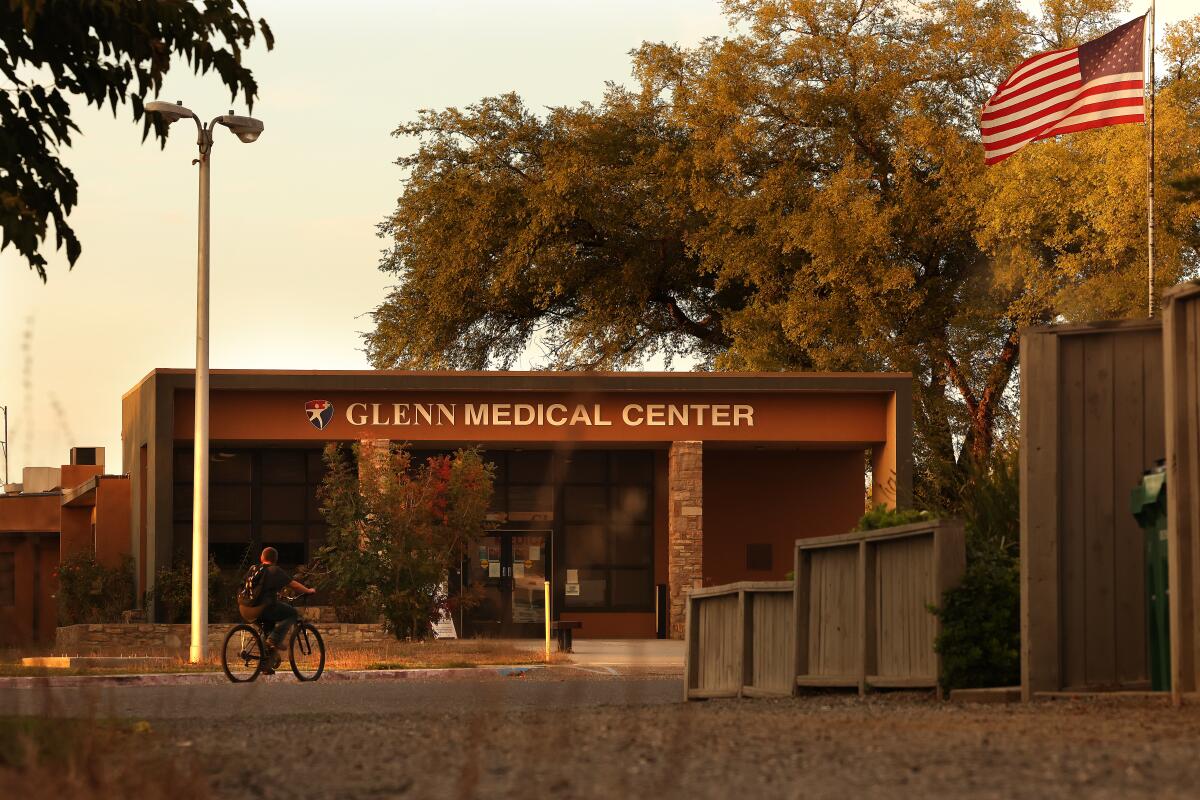 A bicyclist passes by Glenn Medical Center