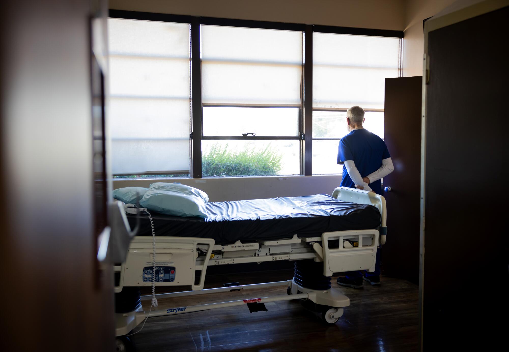 Registered nurse Ronald Loewen, 74, looks out the window on closing day