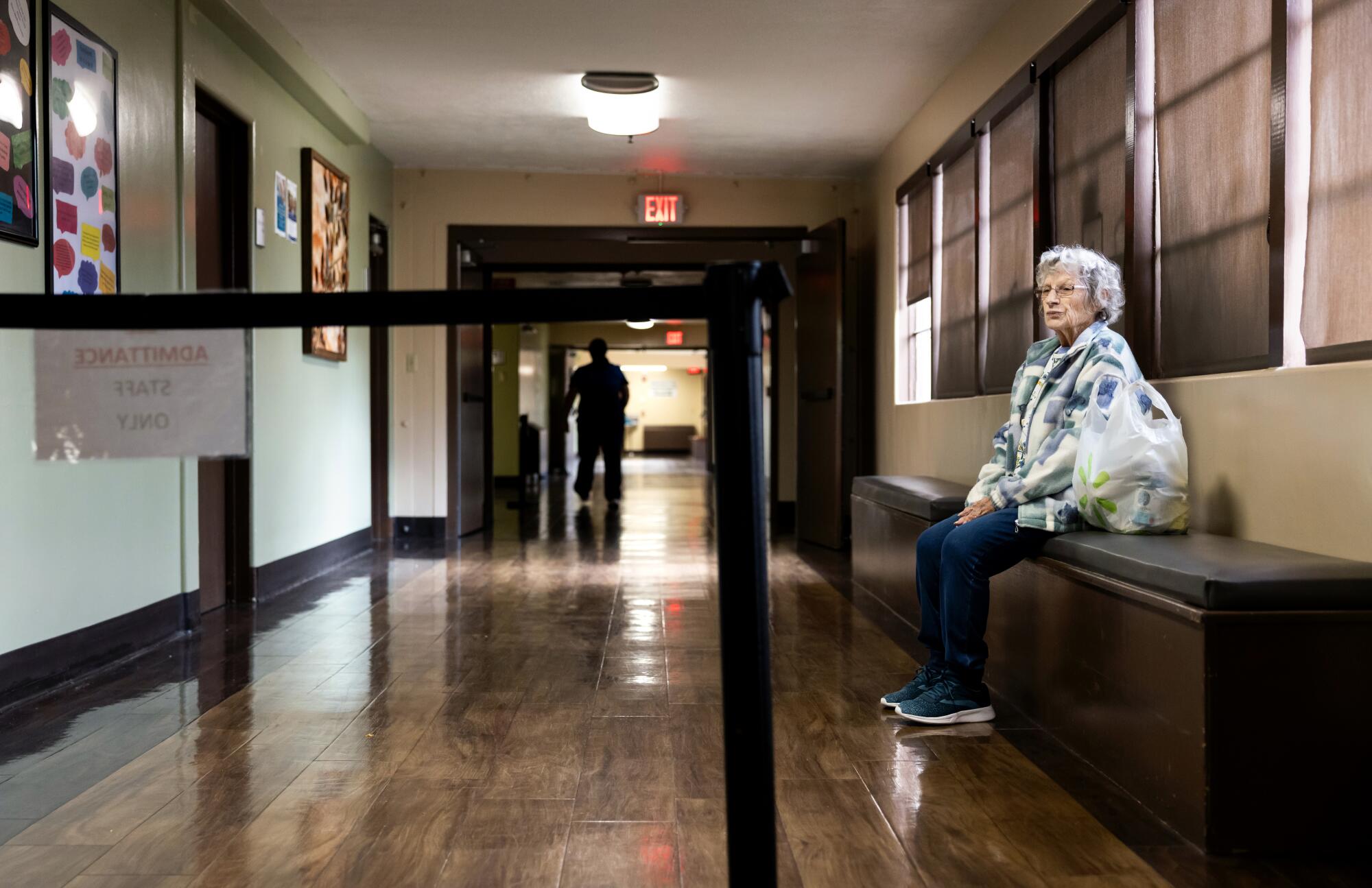 Rose Mary Wampler, 88, waits to have blood drawn at the lab beside a cordoning off, signaling the closure of the hospital