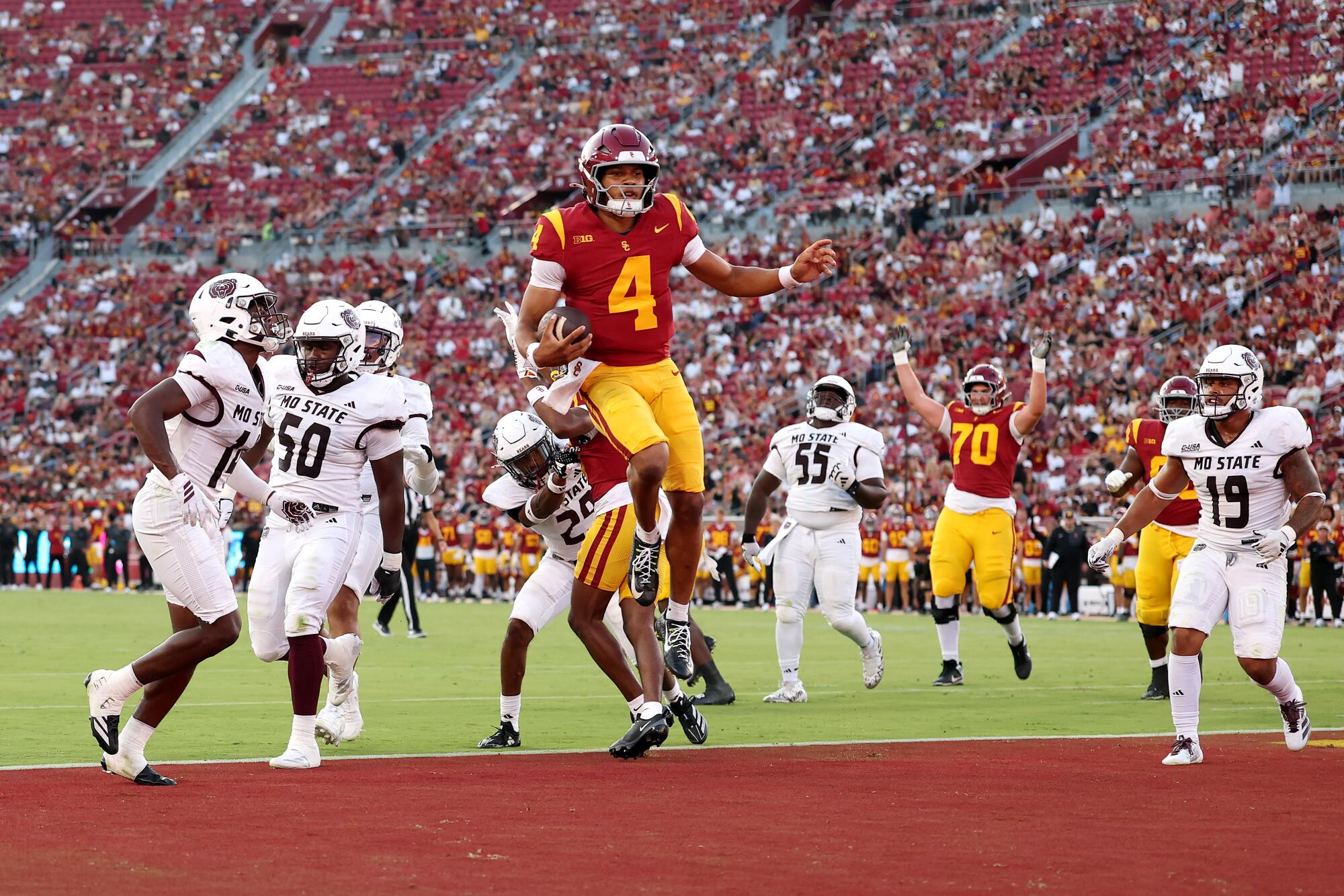 USC quarterback Husan Longstreet  scores a touchdown against Missouri State at the Coliseum on Aug. 30.