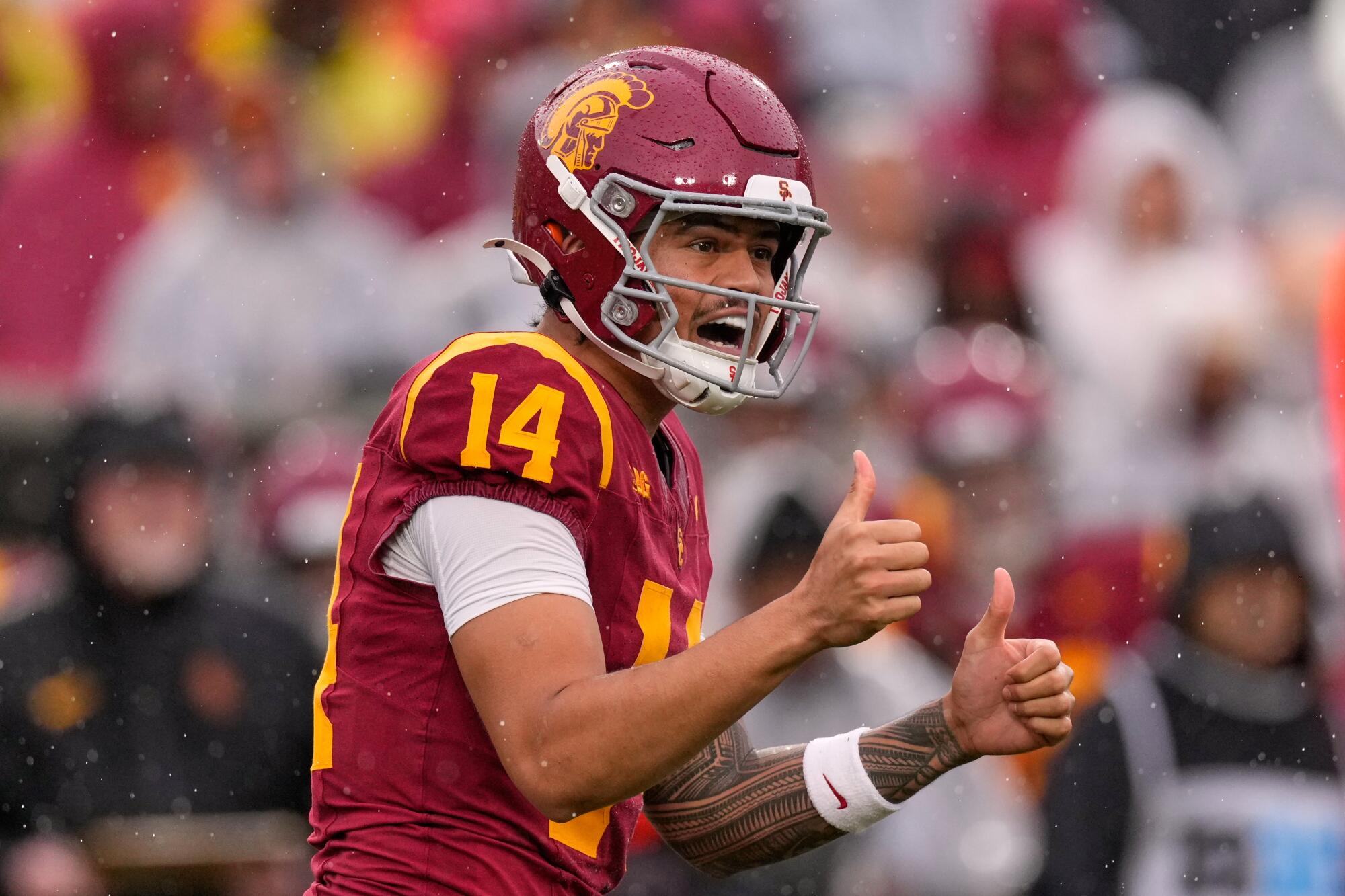 USC quarterback Jayden Maiava gives thumbs up to teammates.