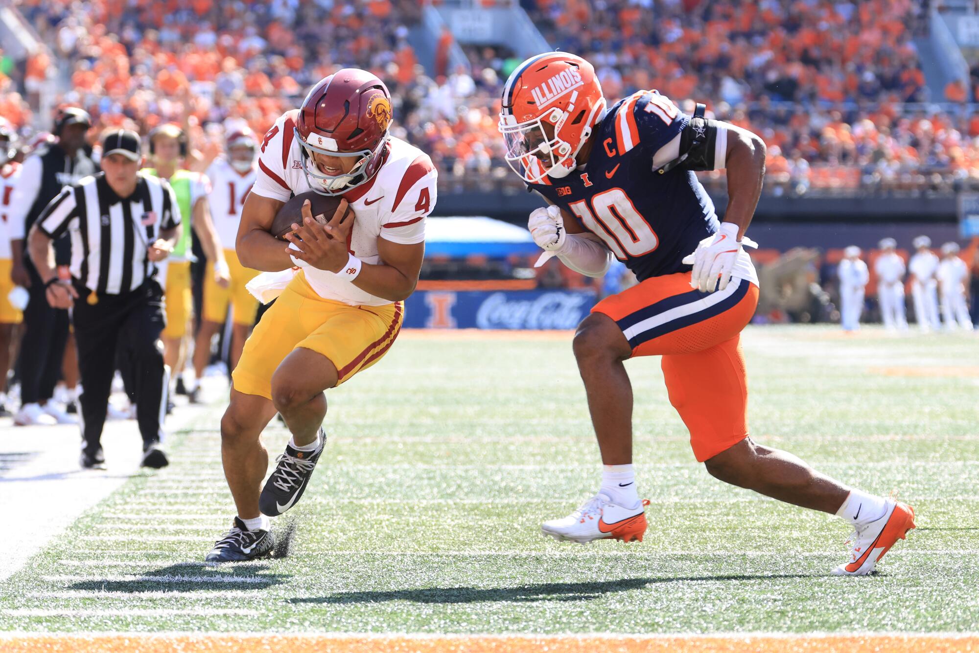USC quarterback Husan Longstreet is pushed out of bounds by Illinois' Miles Scott at Memorial Stadium on Sept. 27.