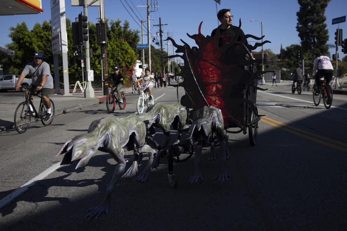Participants bike past a "Demogorgon sleigh" 