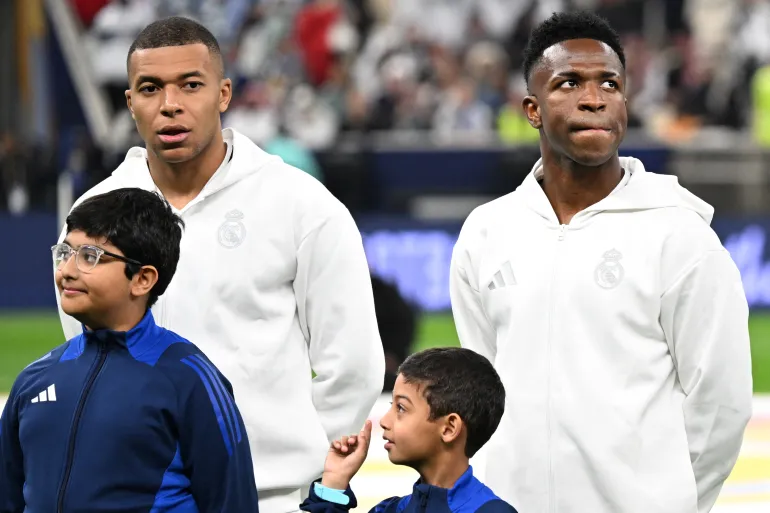 Real Madrid's French forward #9 Kylian Mbappe and Real Madrid's Brazilian forward #7 Vinicius Junior look on ahead of the 2024 FIFA Intercontinental Cup final football match between Spain's Real Madrid and Mexico's Pachuca at the Lusail Stadium in Doha on December 18, 2024. (Photo by Mahmud HAMS / AFP)