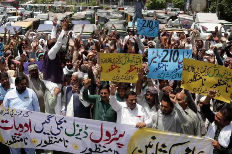 Pakistani rickshaw drivers chant slogans during a protest against the recent increasing in petrol prices, Friday, June 3, 2022. Pakistani government massively increased in petrol to revive IMF program draws. (AP Photo/K.M. Chaudary)