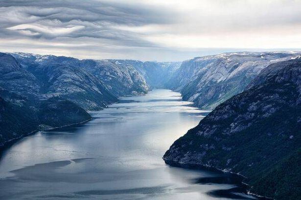 Majestic fjord with steep, snow-capped mountains