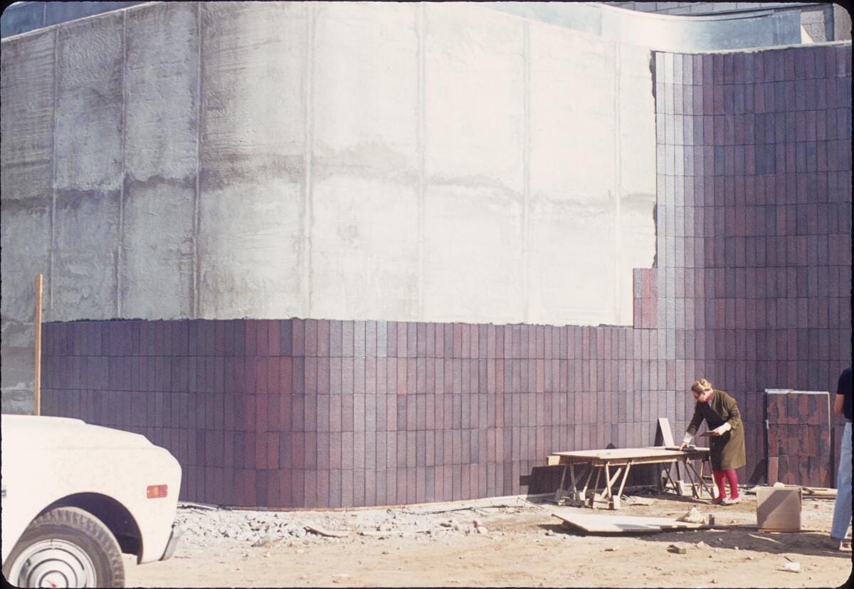 Edith Heath attaching her tiles to the Norton Simon Museum. 