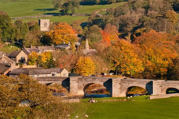 Autumnal trees by an old stone built bridge over the River-Wharfe [stock]