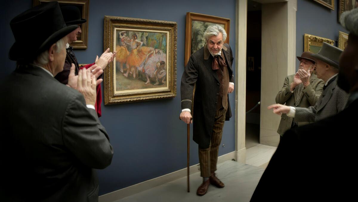 A grey haired man leaning forward on his cane as he stands in front of some artwork hanging in a museum.