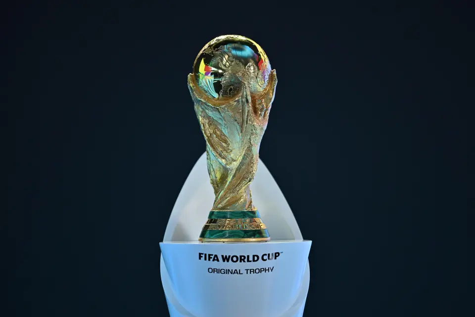 FIFA World Cup Original Trophy on a white stand with "FIFA World Cup Original Trophy" written in black.