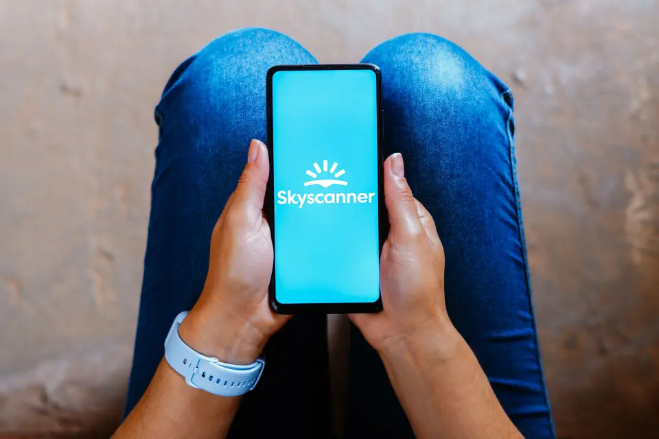 Skyscanner logo on a smartphone screen.