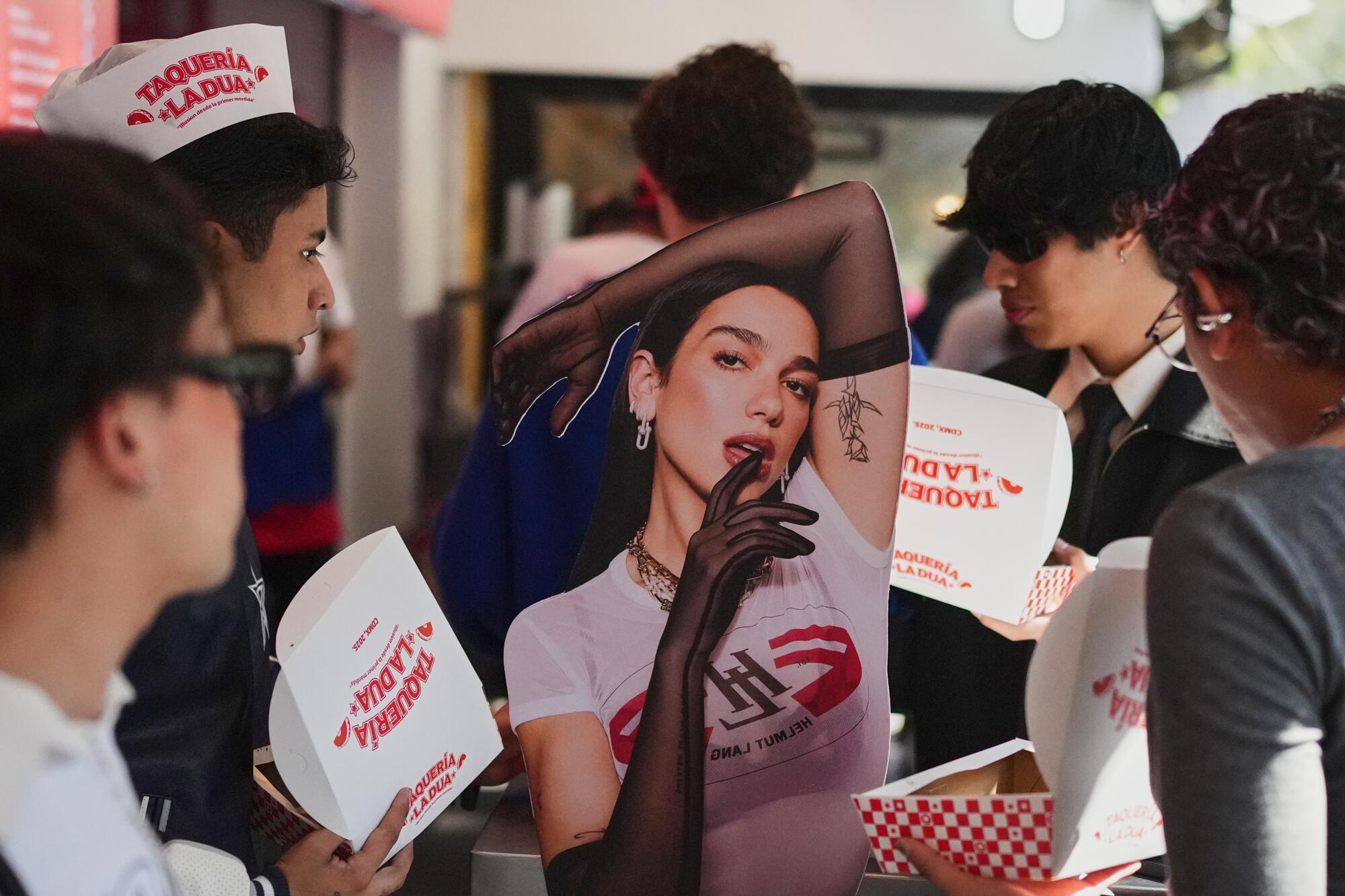 Fans and consumers take part in the opening of Dua Lipa's Taqueria, a pop-up restaurant for her fans in Mexico City, Dec. 1.