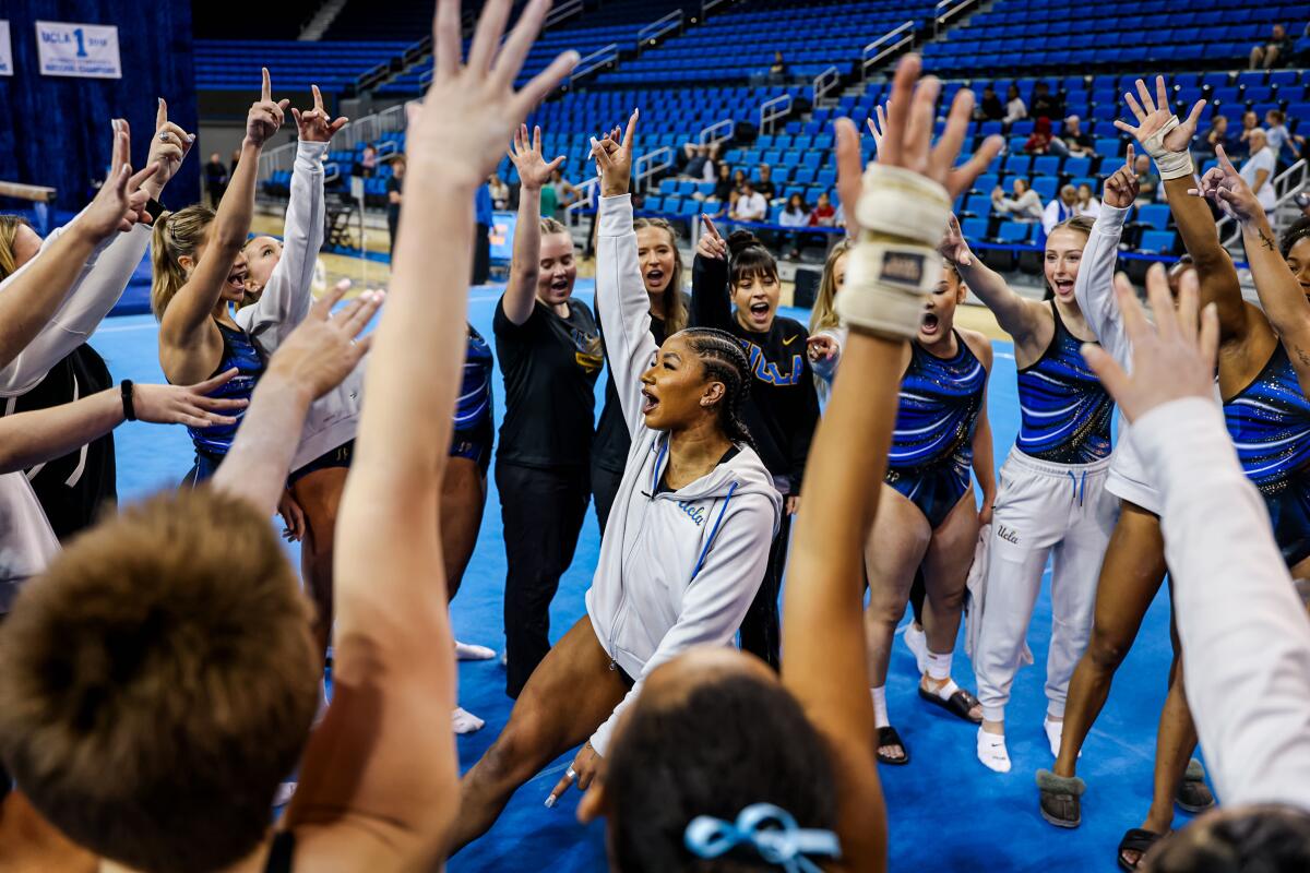 UCLA gymnast Jordan Chiles, center, fires up teammates during the Meet the Bruins exhibition on Saturday.