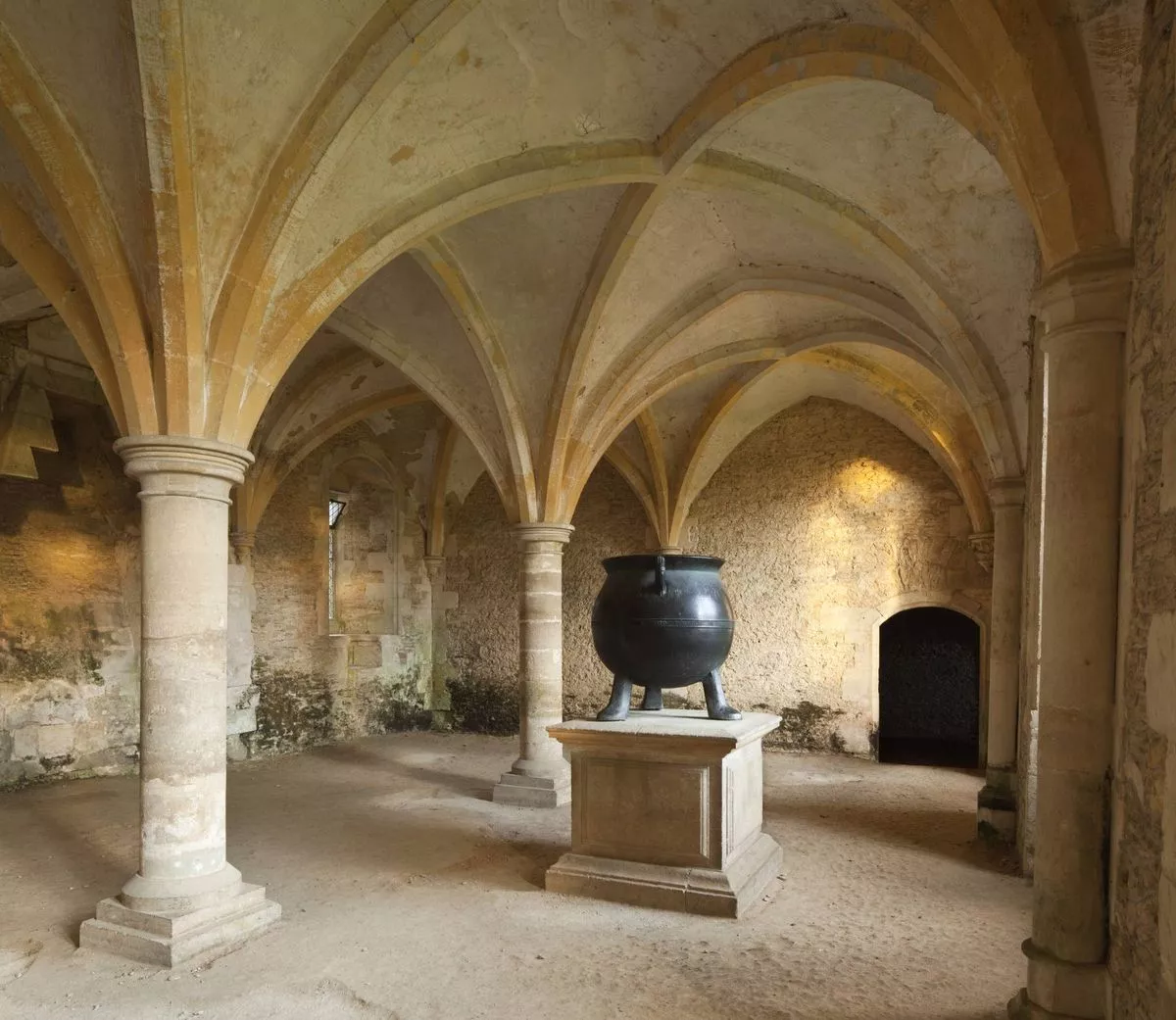 The bell metal cauldron in the Warming Room at Lacock Abbey, Wiltshire.