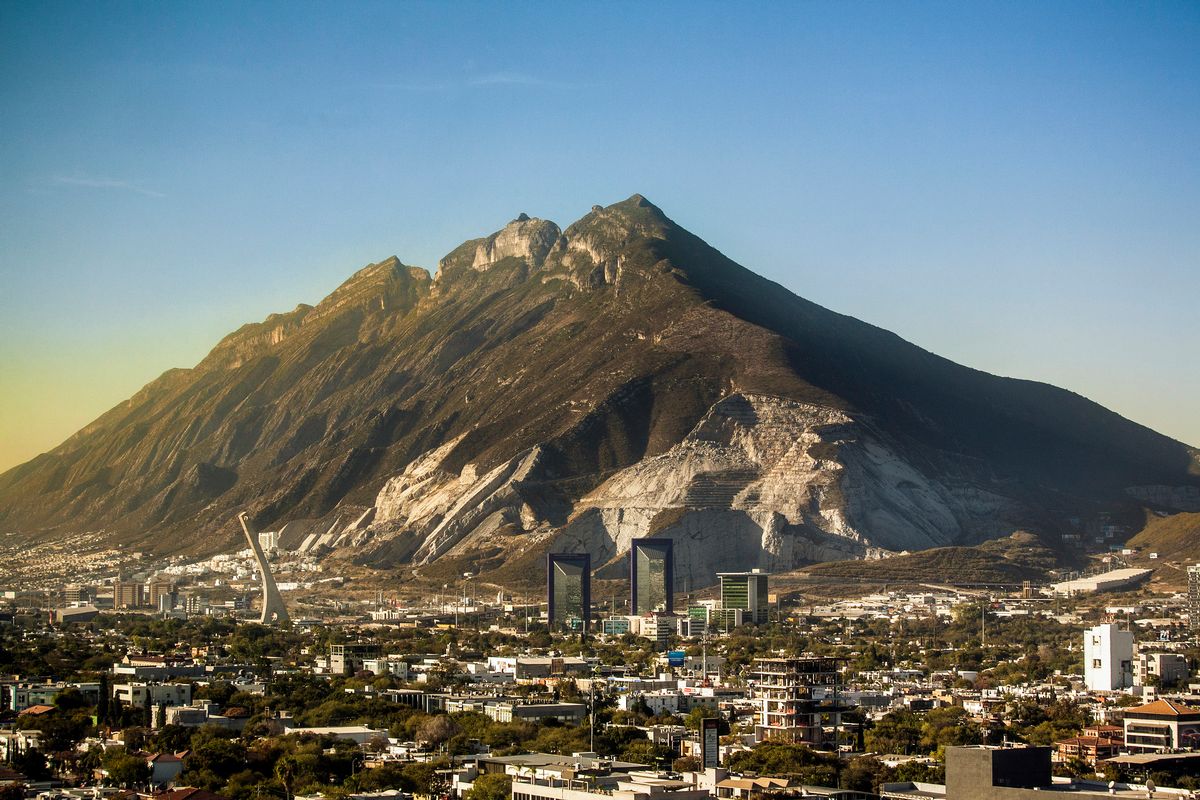Mountain Cerro del Topo Chico rises over northeastern metropolitan and business area of city of Monterrey